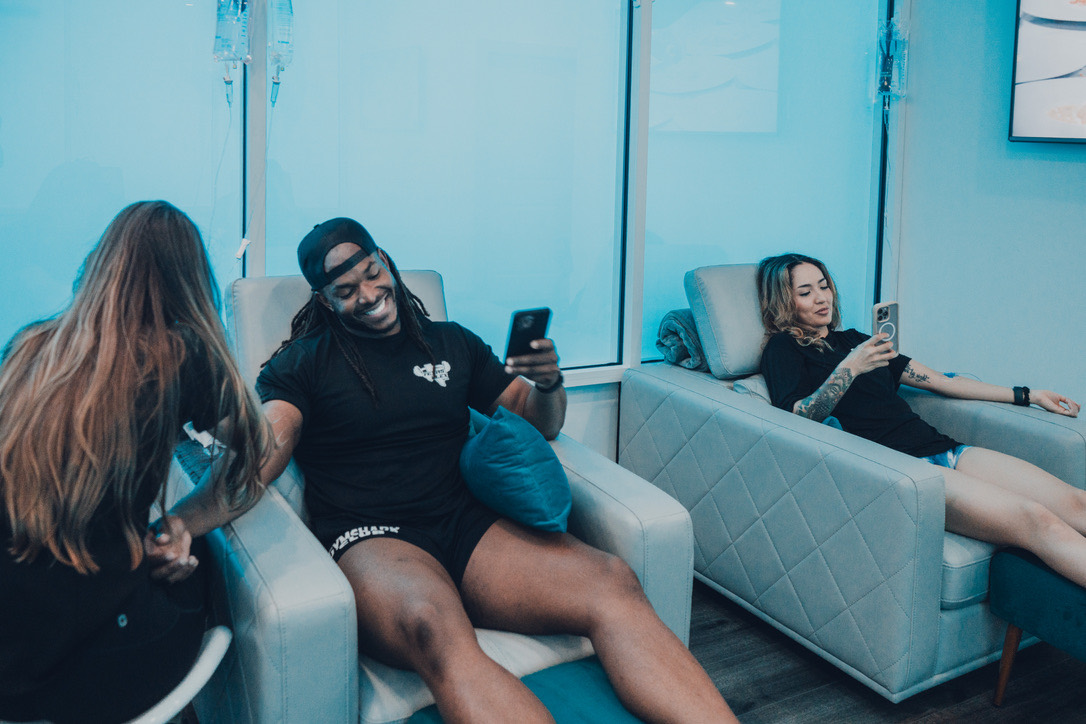 Guests relaxing with IV drips in the ThrIVe Heights lounge